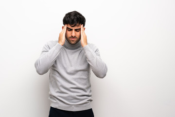 Naklejka premium Young man over isolated white wall with headache