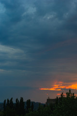 Landscape with dramatic light - beautiful golden sunset with saturated sky and clouds.