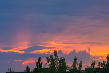 Landscape with dramatic light - beautiful golden sunset with saturated sky and clouds.