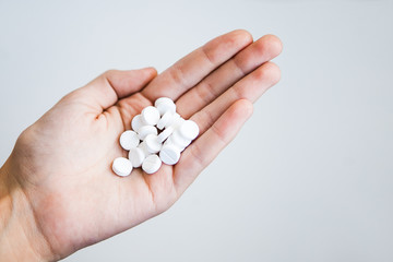 White pills in hand