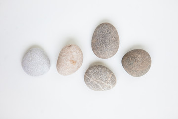 Pebbles on the white ground, flat lay