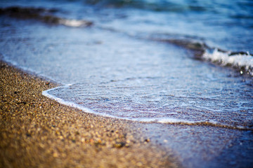 Soft Wave Of Blue Ocean On Pebble Beach.