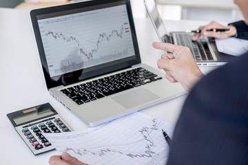 Business team investment working with computer and analysis graph stock market trading with stock chart data, business and technology concept