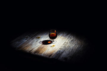 glass with cognac on a wooden background