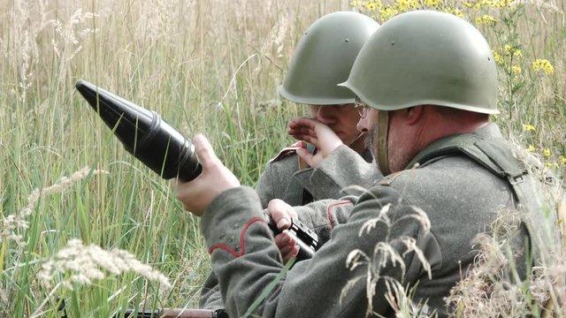 Soldiers load rocket launcher and aim target