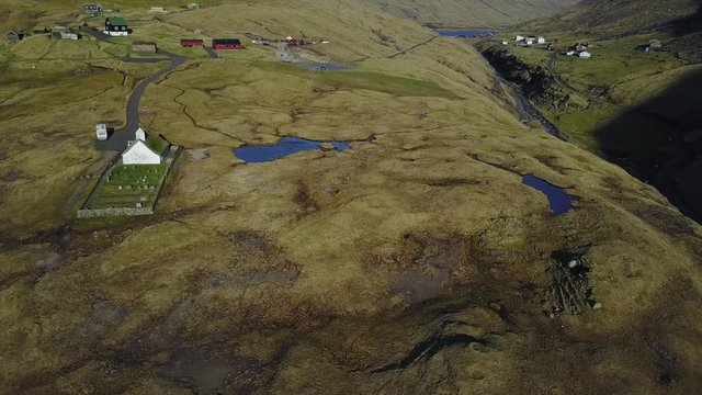 Small village church in Saksun and a nearby lake located on the island of Streymoy, Faroe Islands, Denmark. Shooting a drone quadrocopter,
