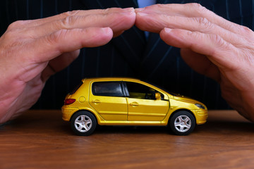 Insurance agent  is protecting car. Concept of auto insurance.