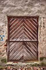 Old wooden door on stone wall