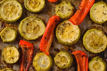 Baked bell peppers and zucchini close-up. Vegetarian dish. Natural plant food. The view from the top.