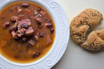Homemade bean soup , vegetables ,bacon and spices. Detail of bowl of bean soup with large beans