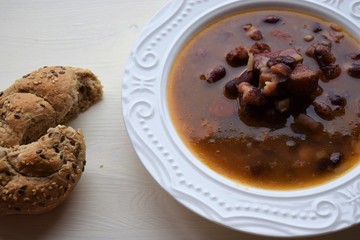 Homemade bean soup , vegetables ,bacon and spices. Detail of bowl of bean soup with large beans