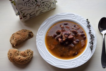 Homemade bean soup , vegetables ,bacon and spices. Detail of bowl of bean soup with large beans