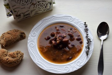 Homemade bean soup , vegetables ,bacon and spices. Detail of bowl of bean soup with large beans