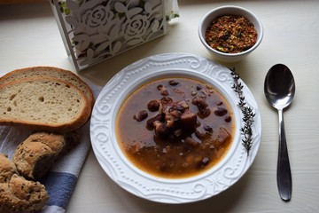 Homemade bean soup , vegetables ,bacon and spices. Detail of bowl of bean soup with large beans
