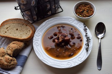Homemade bean soup , vegetables ,bacon and spices. Detail of bowl of bean soup with large beans