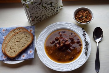 Homemade bean soup , vegetables ,bacon and spices. Detail of bowl of bean soup with large beans