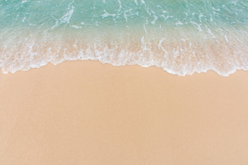 Fototapeta na wymiar Soft wave of sea on empty sandy beach Background with copy space