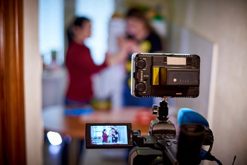 Professional camera recording interview on a blurred background.