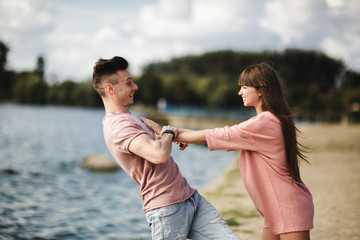 crazy young couple emotionally having fun, kissing and hugging outdoors. Love and tenderness, romance, family, emotions, fun. having fun together