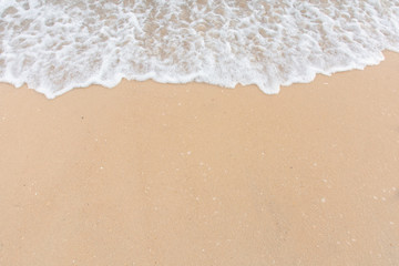 Soft wave of sea on empty sandy beach Background with copy space