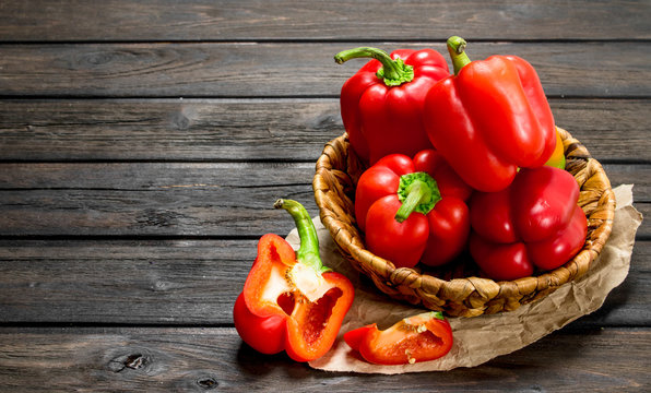 Ripe Red Sweet Peppers In A Basket On Paper.