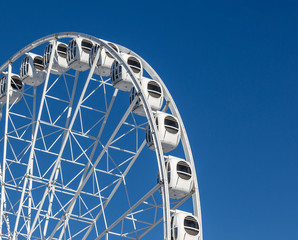 white ferris wheel on blue background