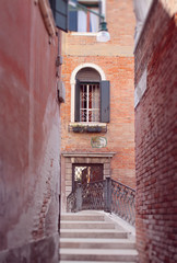 Fototapeta na wymiar A street in Venice, Italy, over Canal