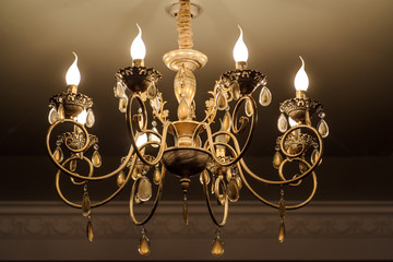 close up photo of chrystal chandelier lamp on the ceiling of a banquet hall