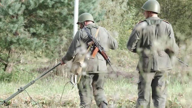 Two soldiers search for mines