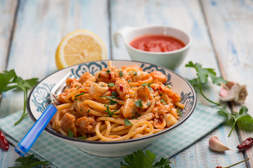 spaghetti with squid tomato sauce parsley and hot chili pepper