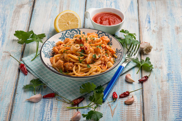 spaghetti with squid tomato sauce parsley and hot chili pepper