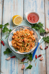 spaghetti with squid tomato sauce parsley and hot chili pepper