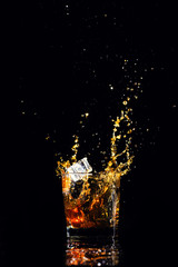 whiskey with splash on black background