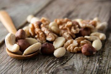 Nuts mix over wooden background. Energy super food. Proteine food. dieting, healthy food. Isolated nuts - almonds, hazelnuts,cashew, brazil nuts.