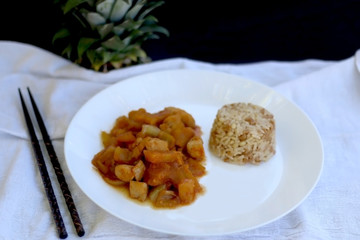 Thai chicken with pineapple, served with rice. Selective focus.