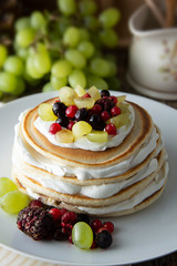 Stack of homemade pancakes or crepes with cream, yougurt fresh berries. Delicious breakfast. Pastry. Healthy food.