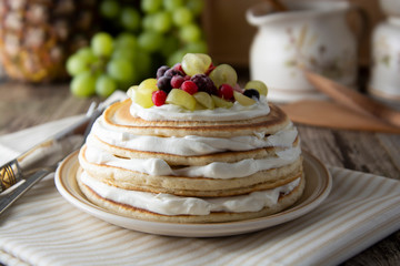 Stack of homemade pancakes or crepes with cream, yougurt fresh berries. Delicious breakfast. Pastry. Healthy food.