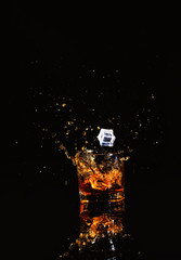 whiskey with splash on black background