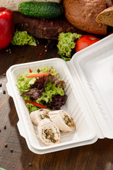 Vegetable rolls and salad in a box - take it with you.. Healthy food delivery. Take away for diet. Fitness nutrition, vegetables, meat and fruits in eco box. Close up. Space