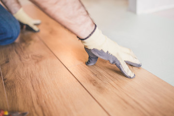 Professional flooring installation - laying a new laminate with a wooden pattern