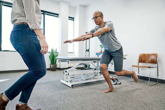 Physiotherapist examining a patient in clinic