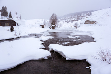 Fototapeta na wymiar winter landscape with ruined dam