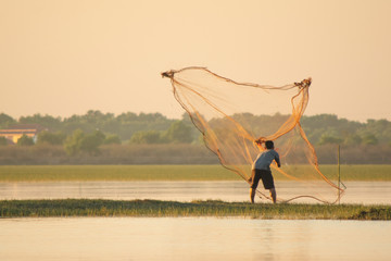 NAKHON PHANOM, THAILAND - Nov 4, 2018 : Fisherman casting a net into the lake