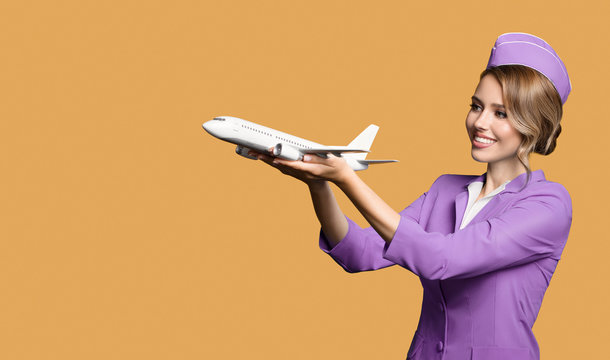 Cheerful Stewardess Holding Airplane In Hand.