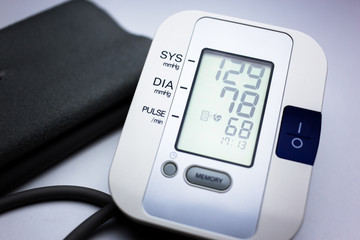 Blood pressure and pulse measuring device with normal blood pressure reading. Heart health, healthcare and medical concept
