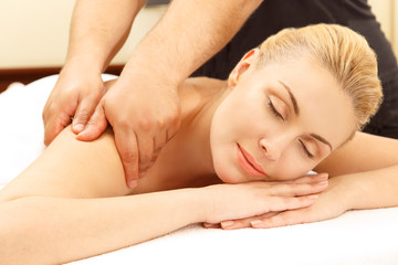 Obraz na płótnie Canvas Massage day. Horizontal portrait of a beautiful woman enjoying her massage session