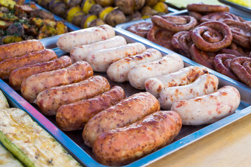 Grilled sausages are sold on the fair.