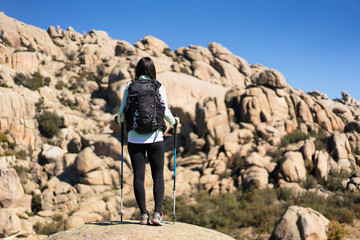 A young woman hiker in La Pedriza, National Park of mountain range of Guadarrama in Manzanares El Real, Madrid, Spain.