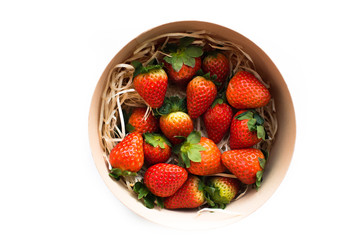 Delicious fresh strawberries in a round wooden box, top view