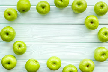 green apples for organic summer food pattern on light wooden background top view mockup